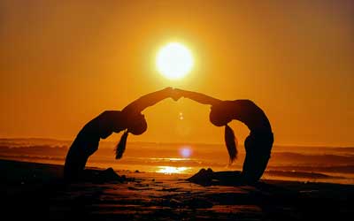 yoga on the beach at sunset