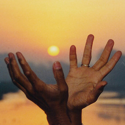 The lotus hand mudra capturing the dawn sunlight